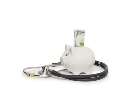  piggy bank with stethoscope isolated on white

