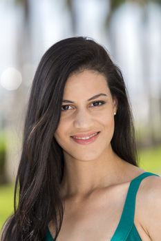 Portrait of a young hispanic woman, outdoors. 