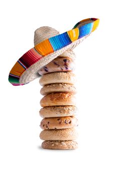 Close up Piled Bagel Breads with Mexican Hat on the Top, Isolated on a White Background.