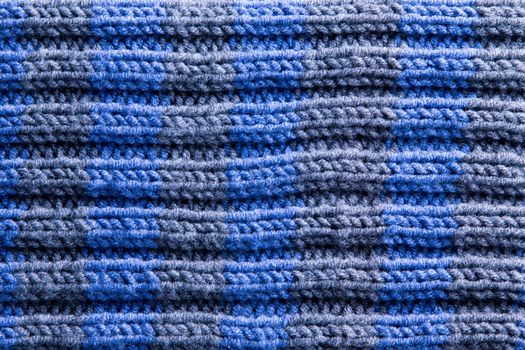 Close up Homemade Crochet in Blue and Gray Colors with Horizontal Pattern of Ridge Lines. Can be Used for Background Designs.