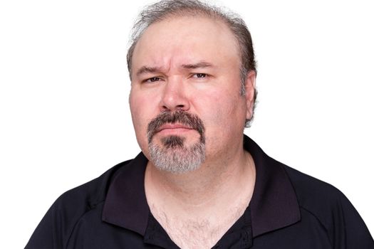 Puzzled middle-aged man with a goatee frowning and looking at the camera with a look of distrust isolated on white