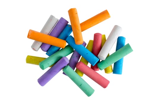 Heap of multicolored chalk crayons for children to practice their creativity and drawing skills viewed from above isolated on a white background