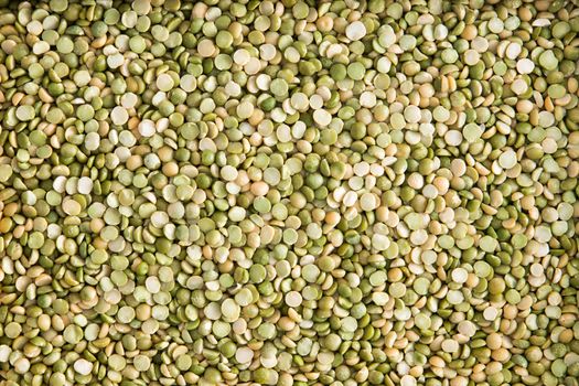 Background texture of healthy dried green lentils rich in protein viewed overhead as a full frame layer