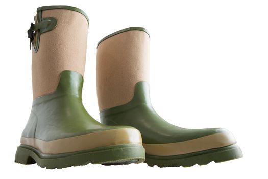 Fun wide low angle view of a pair of rugged green and beige calf-high gardening boots with heavy soles isolated on white