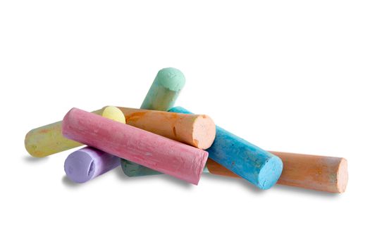 Close up side view of a pile of colorful chalks for kids to play with making erasable drawings, on white with copyspace