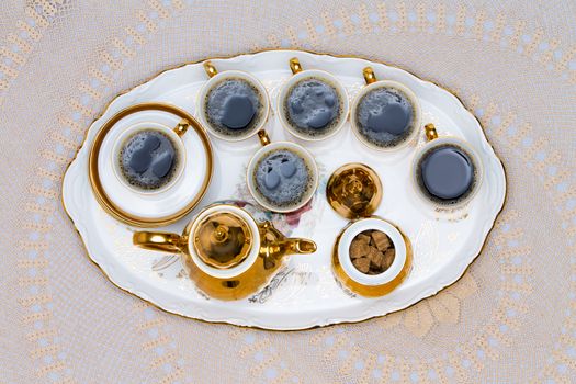 Close up Six Cups of Turkish Coffee on White Tray Served on White Table in High Angle View.