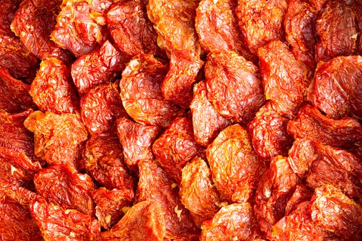 Background texture of neatly arranged ripe red sundried tomatoes, a healthy snack and appetizer rich in antioxidants and vitamins