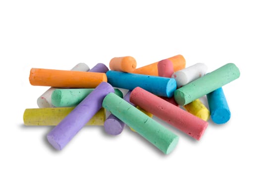 Collection of bright colorful chalk crayons piled in a random heap ready for young elementary school children to use for creative drawing and entertainment, on white