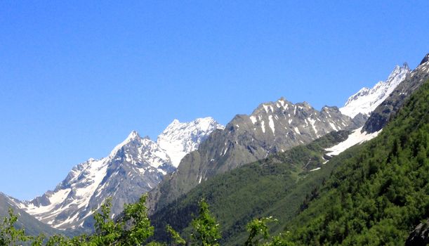 Caucasus Mountains Under Snow And Clear Blue Sky