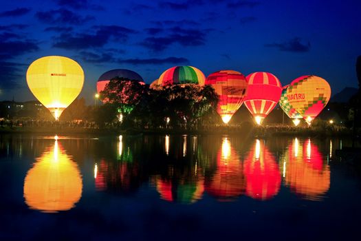 Hot air baloon starting to fly in the evening sky