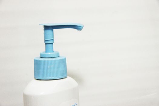 White and blue dispenser on the bottle of cleaning liquid