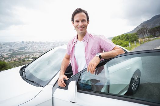 Man smiling at camera at the side of the road