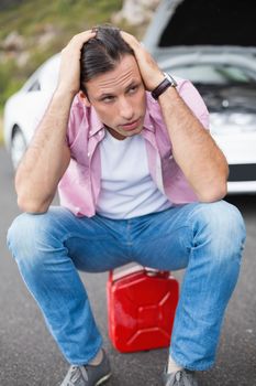 Stressed man after a car breakdown at the side of the road