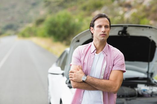 Man waiting assistance after a car breakdown at the side of the road