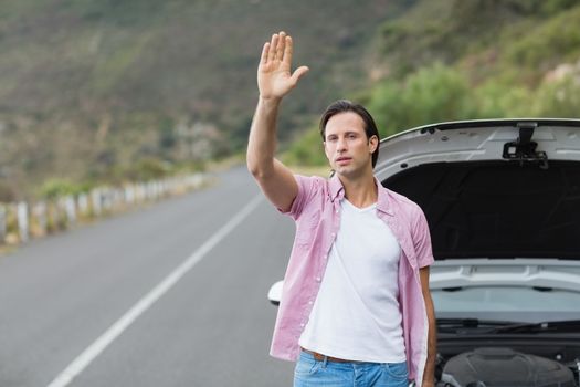 Man waving after a breakdown at the side of the road