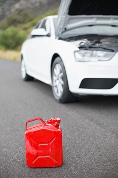 A petrolcan next to car after a breakdown at the side of the road