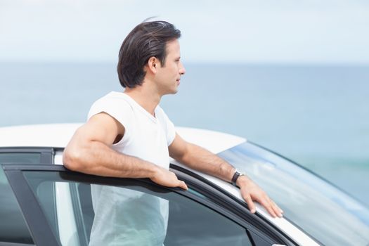 Man leaning on the door of his car