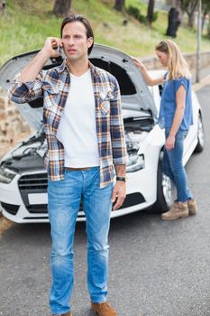 Couple after a car breakdown at the side of the road