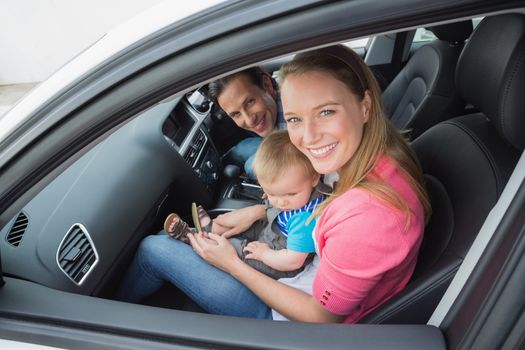 Parents and baby on a drive in their car