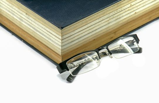 Old text book or bible with eyeglasses