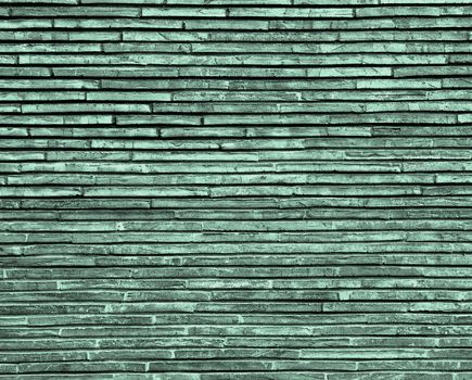 Background of Grey and Green Plank Stone Exterior Wall closeup