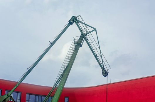 Old Port crane in front of a modern building.