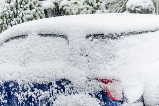 Parked SUVs with snowy roof.