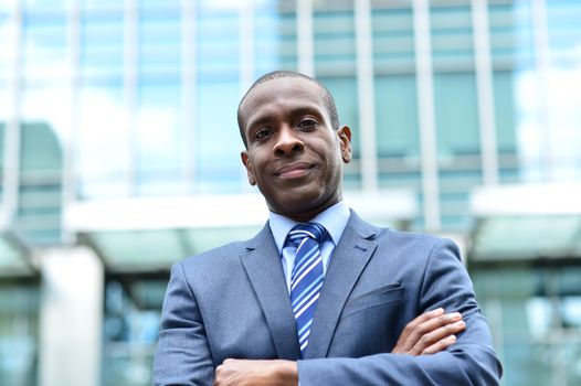 Arms crossed businessman posing at outdoors