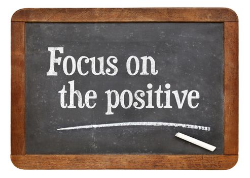 Focus on the positive - inspirational advice n on a vintage slate blackboard