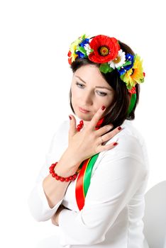 beautiful young brunette woman wearing national ukrainian clothes posing in studio on white background