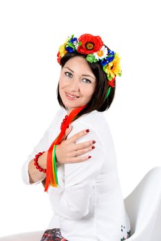 beautiful young brunette woman wearing national ukrainian clothes posing in studio on white background