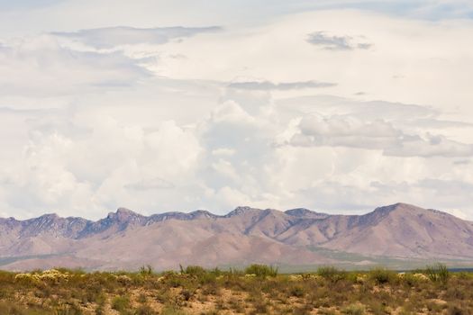 Thunderstorm clouds gathering above Arizona mountains in desert