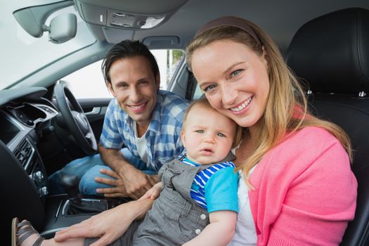 Parents and baby on a drive in their car