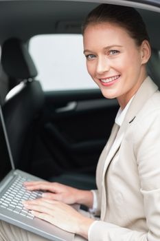 Businesswoman working in her car