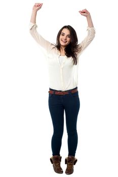 Full length portrait of a gorgeous young girl dancing in joy.