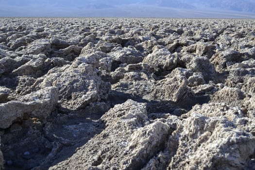 Devil's golf court is formed by salt formation remaining of a salty see that got dried up many millennia ago