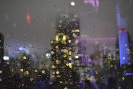 Empire State in the background on a photography focused on a wet glass after a storm