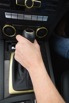 Woman using gearshift in her car