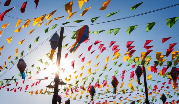 Bunting, colorful party flags, on a blue sky.