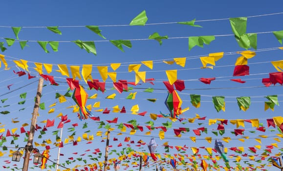 Bunting, colorful party flags, on a blue sky.