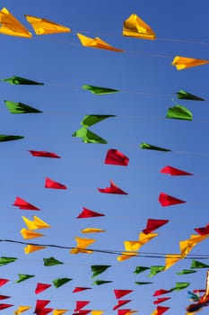 Bunting, colorful party flags, on a blue sky.