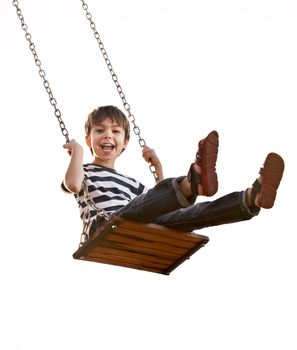 Cute boy playing on swing, having fun. On a white background.