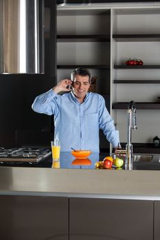 man talking phone in the kitchen