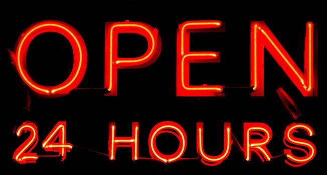 Open 24 Hours neon sign on black background