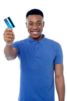 Young man showing his debit card to camera