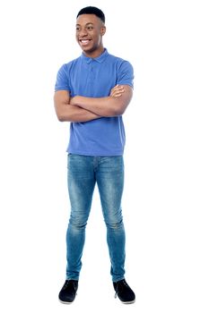Confident young man posing with folded arms