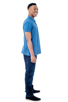 Full length image of young man posing sideways