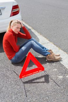 Triangle warning sign with broken down car 