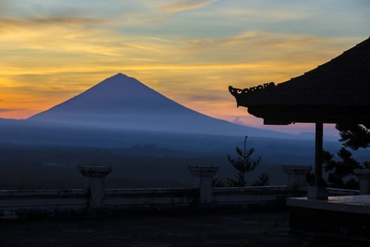 Man with and Volcano Agung as Background at Sunrise Time,Bali,Indonesia.