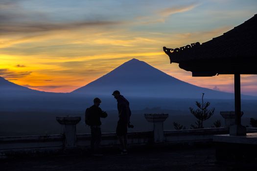 Man with and Volcano Agung as Background at Sunrise Time,Bali,Indonesia.
